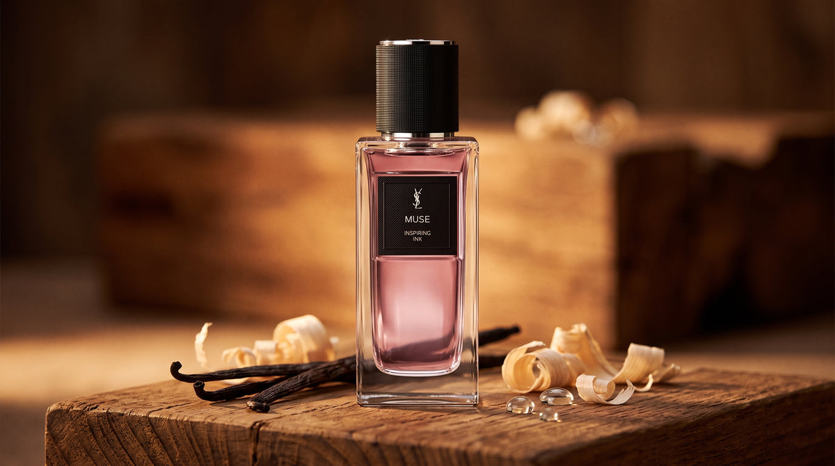 Yves Saint Laurent Muse Inspiring Ink EDP on aged teak with vanilla pods and pale wood shavings