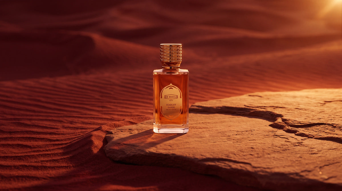 Ex Nihilo Scarlet Sands eau de parfum on warm sandstone at the edge of red desert dunes at sunset