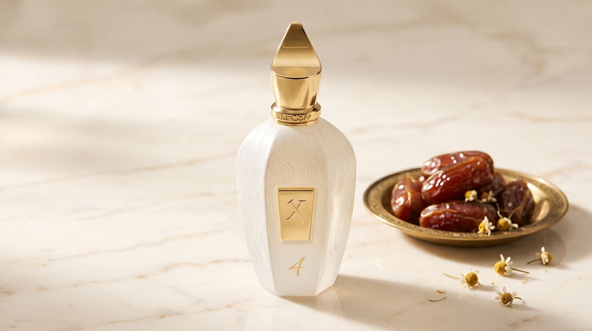 Xerjoff Four white UAE Exclusive bottle on pale cream marble beside a brass dish of Medjool dates and dried chamomile