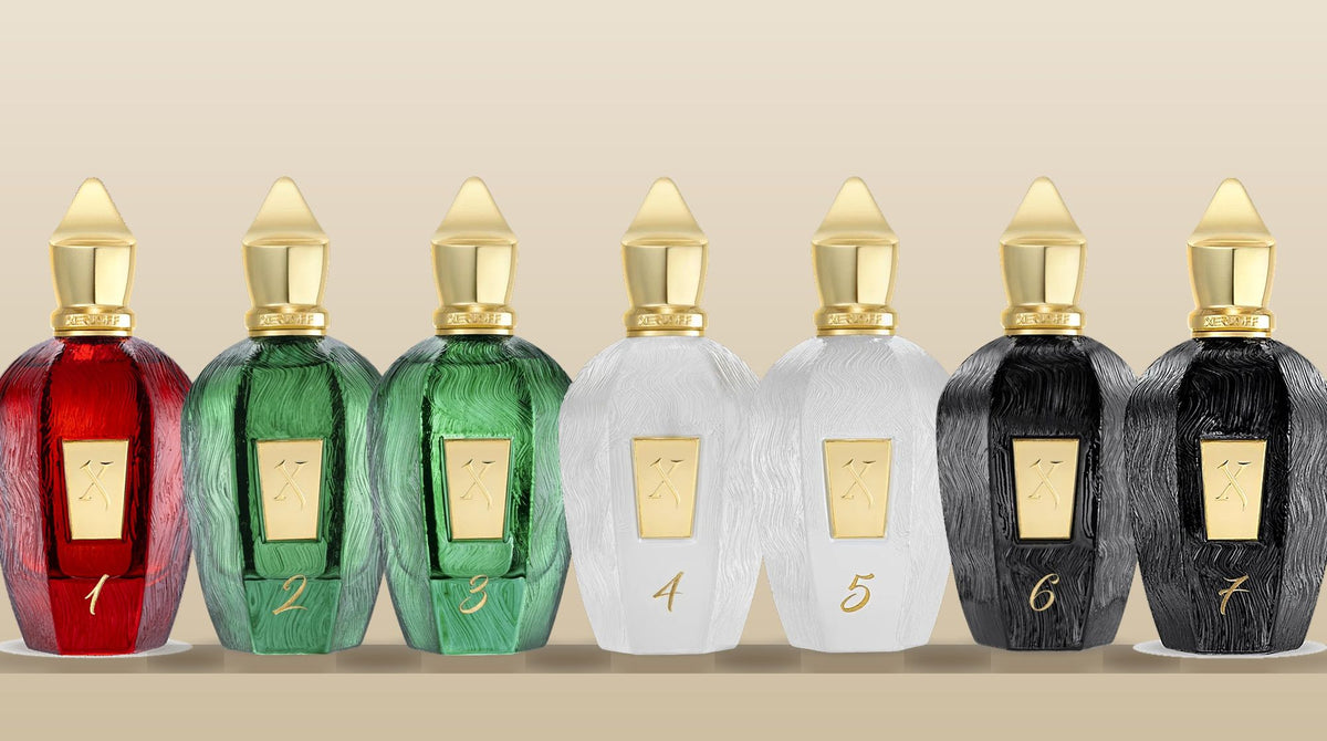 All seven Xerjoff UAE Exclusive bottles in a row, numbered 1 to 7, in red, green, white and black glass with gold caps