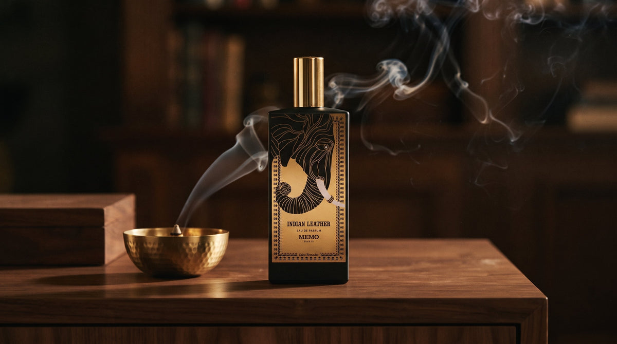 Memo Paris Indian Leather bottle with its elephant motif on a walnut cabinet beside a brass incense bowl