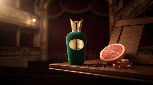 Sospiro Basso green velvet bottle on a walnut ledge in an opera box beside grapefruit, black peppercorns and cedar