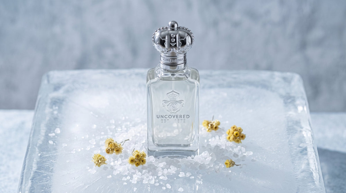 Clive Christian Uncovered bottle on a frosted block of ice with sea salt crystals and small yellow immortelle flowers