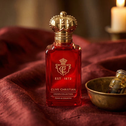 Clive Christian Town and Country on raw silk of oxblood color with a brass bowl of ambergris tincture