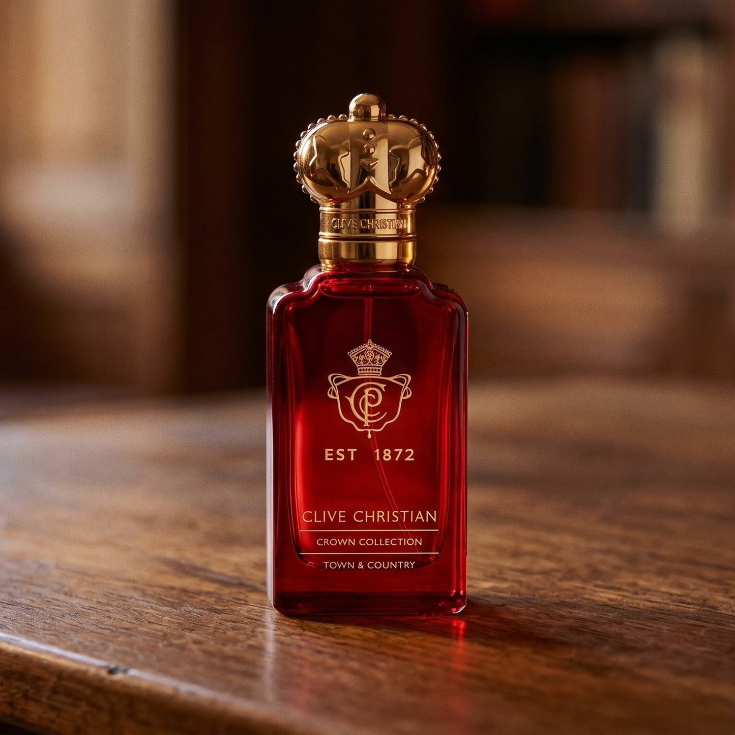 Clive Christian Town and Country on aged teak with a candle burning gently to frame-right