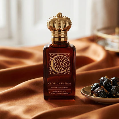 Clive Christian Private Collection (Woody/Leather/Oud/Amber) on amber-toned satin with a gold-rim ceramic dish of labdanum
