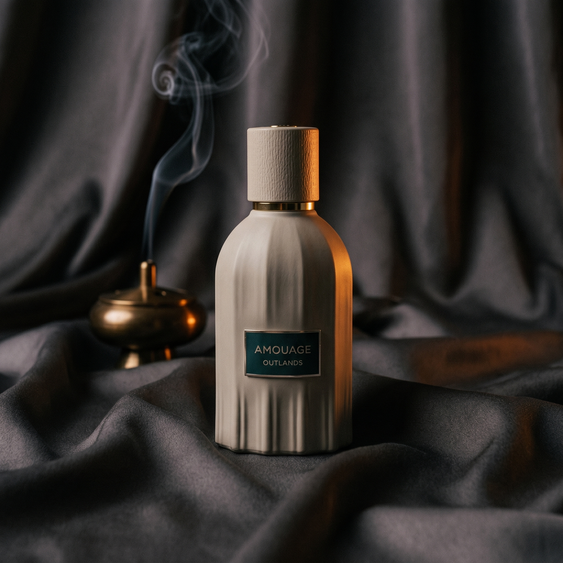 Amouage Outlands EDP centered on charcoal silk with a brass incense burner