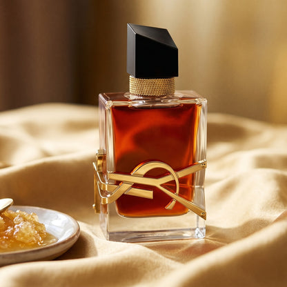 Yves Saint Laurent Libre EDP on golden silk with a small dish of crystallized honey