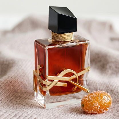Yves Saint Laurent Libre EDP on pale taupe knit with a crystallized kumquat nearby