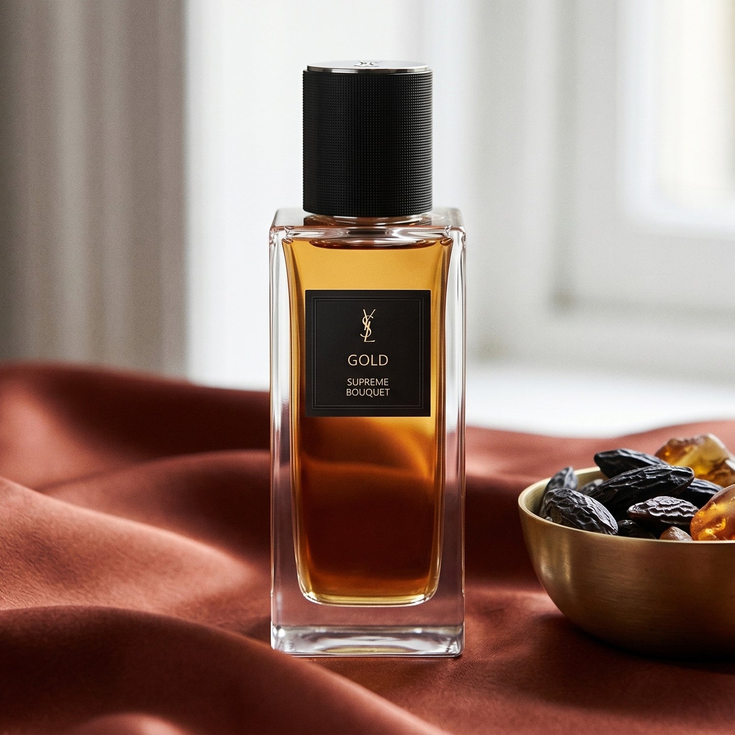 Yves Saint Laurent Supreme Bouquet EDP on russet silk with a matte brass bowl holding tonka and amber pieces
