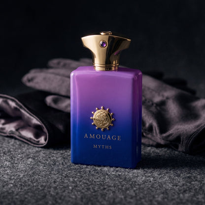 Amouage Myths Man on charcoal felt with a silk-lined glove just behind the bottle