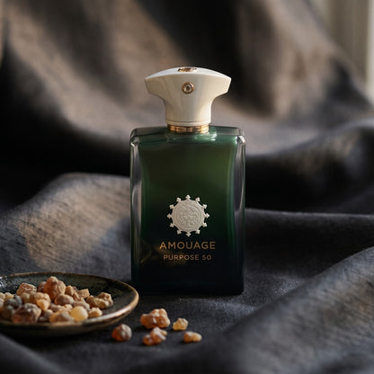 Amouage Purpose 50 Extrait on charcoal silk with frankincense resin granules in a small saucer