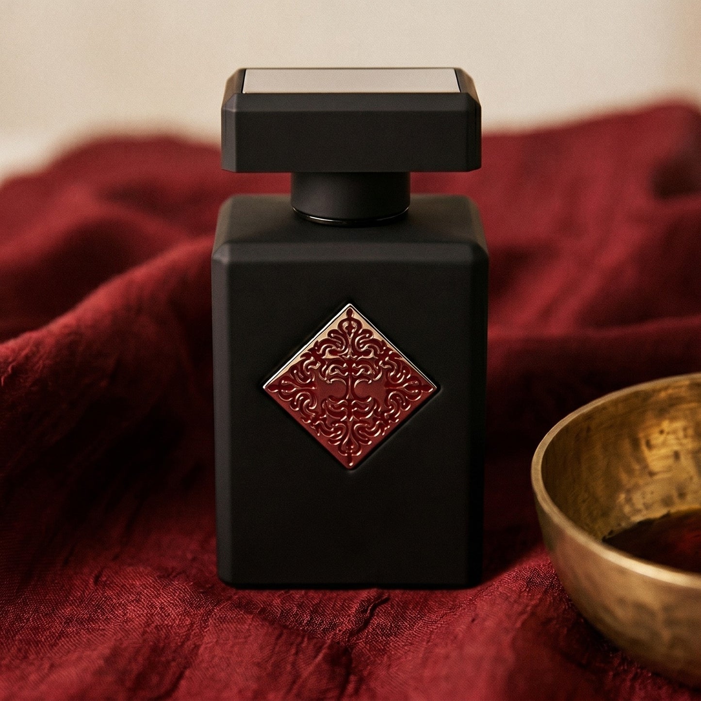 Initio Mystic Experience EDP on raw silk of oxblood color with a brass bowl with ambergris tincture