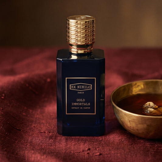 Ex Nihilo Gold Immortals Extrait EDP on raw silk of oxblood color with a brass bowl with ambergris tincture