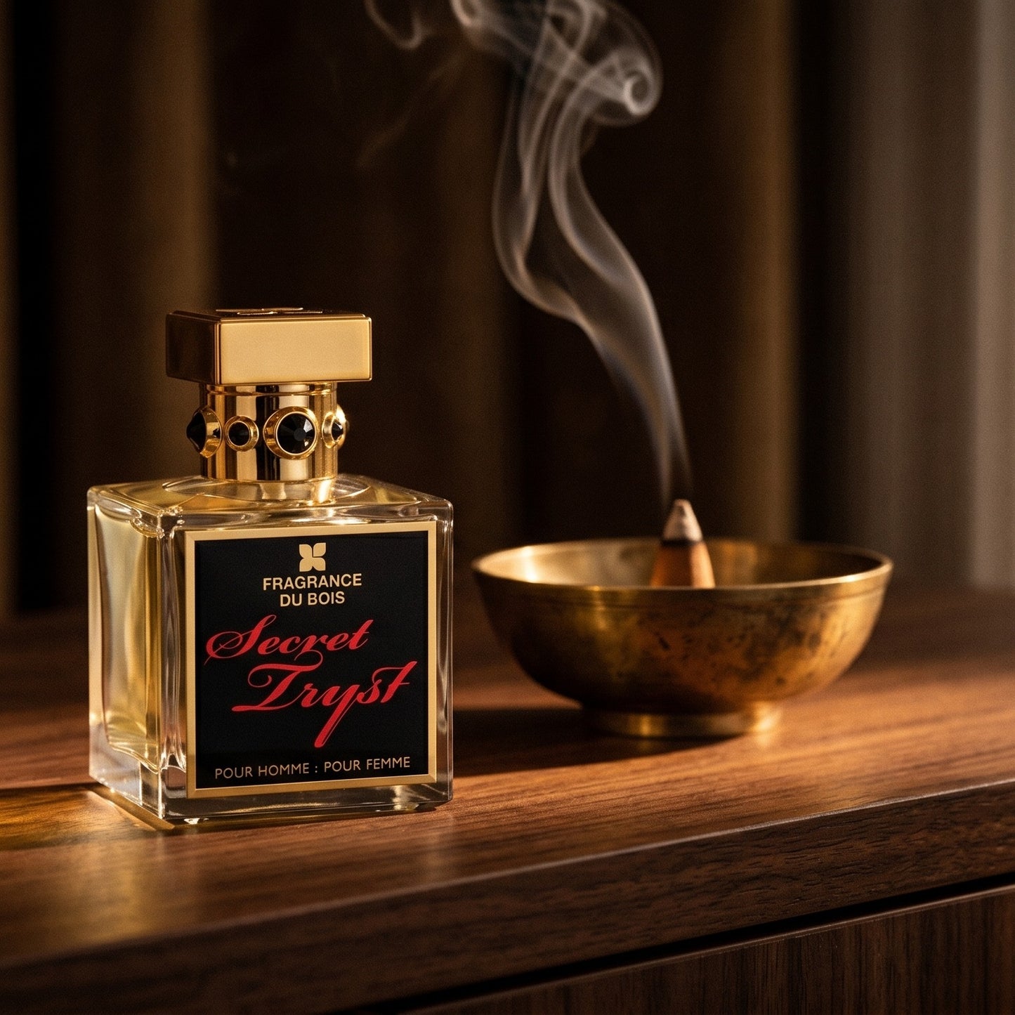Fragrance Du Bois Secret Tryst on dark walnut console with a small brass incense bowl with smoke curling upward
