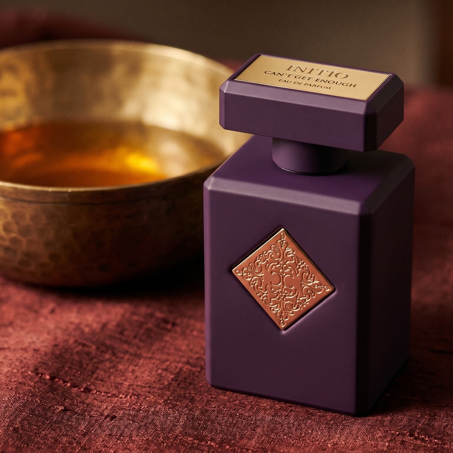 Initio Can't Get Enough EDP on raw silk of oxblood color with a brass bowl with ambergris tincture