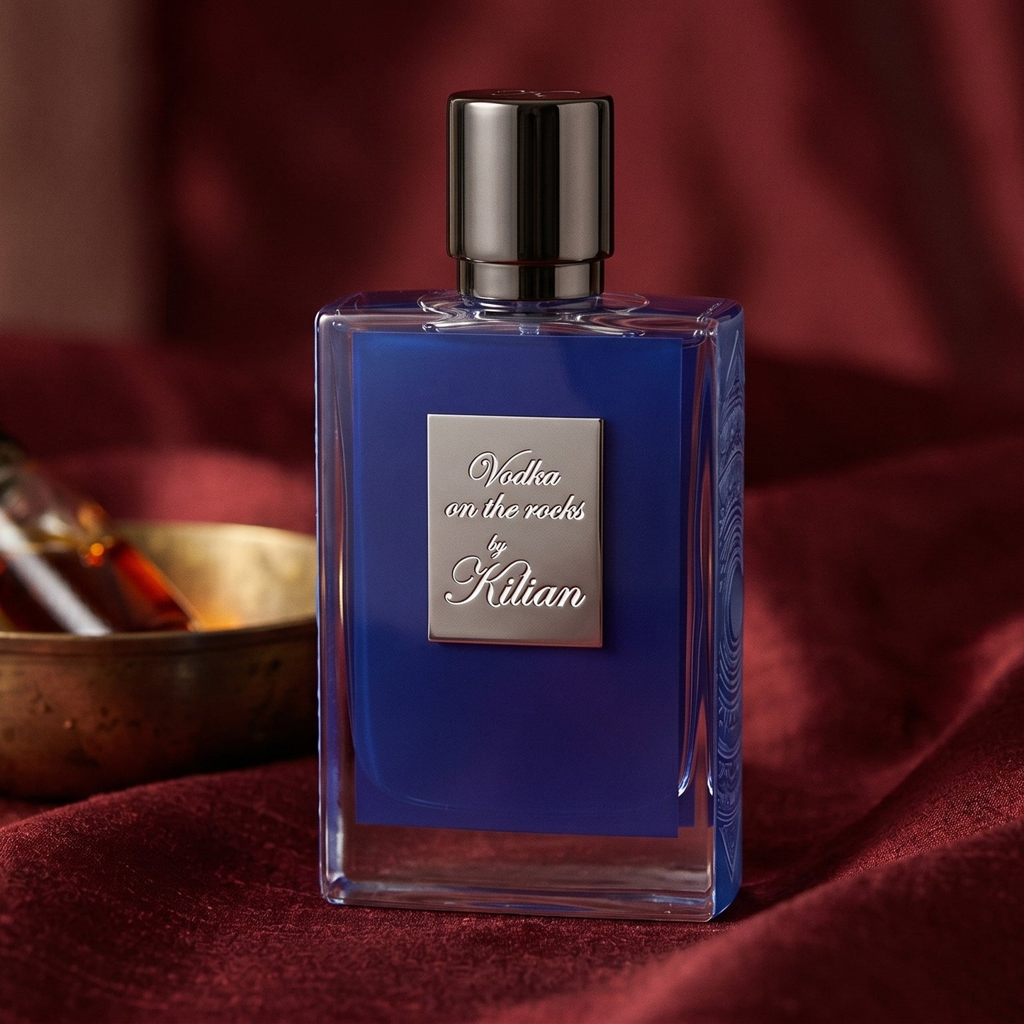 Kilian Vodka On The Rocks EDP on raw silk of oxblood color with a brass bowl with ambergris tincture
