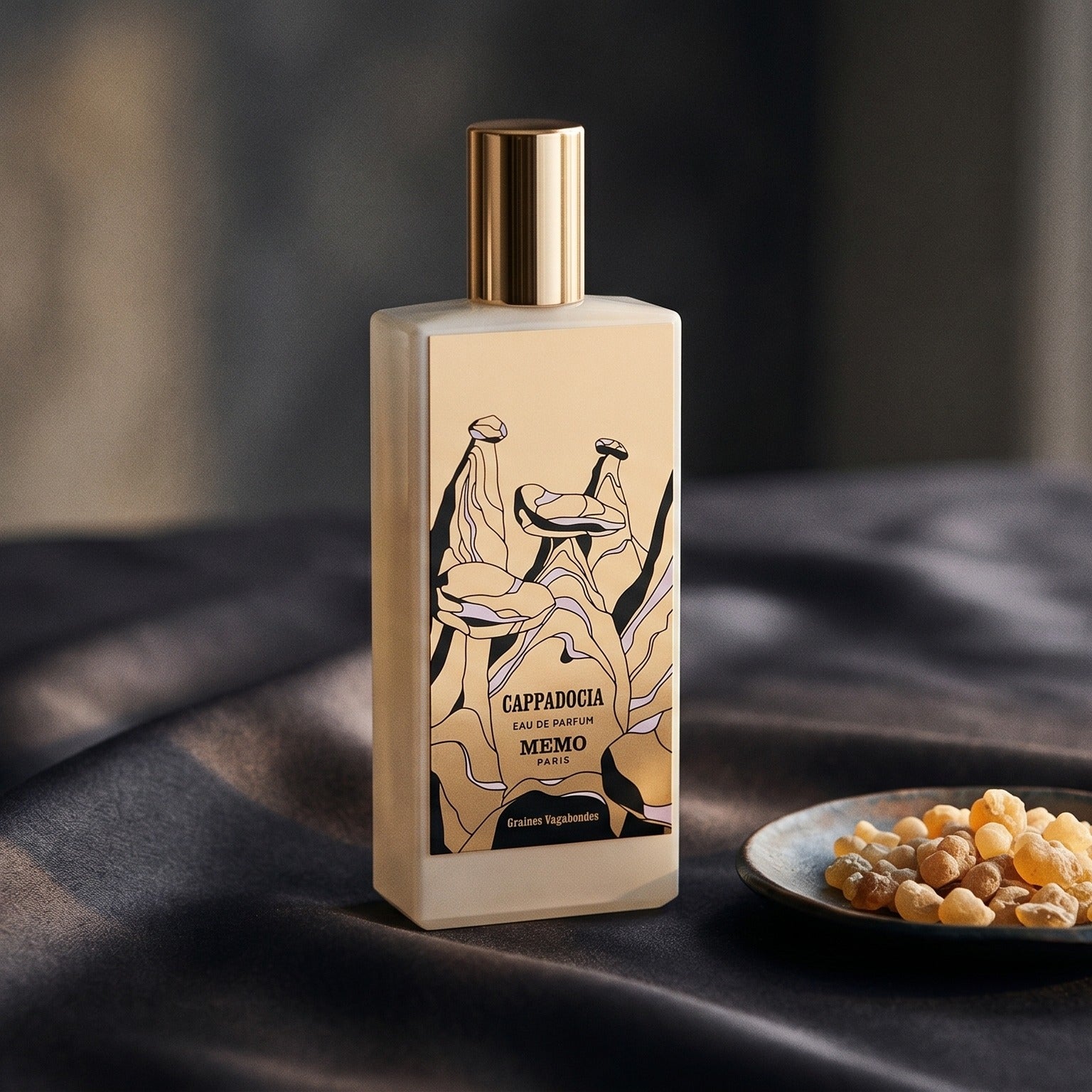 Memo Paris Cappadocia EDP on charcoal silk with frankincense resin granules in a small saucer