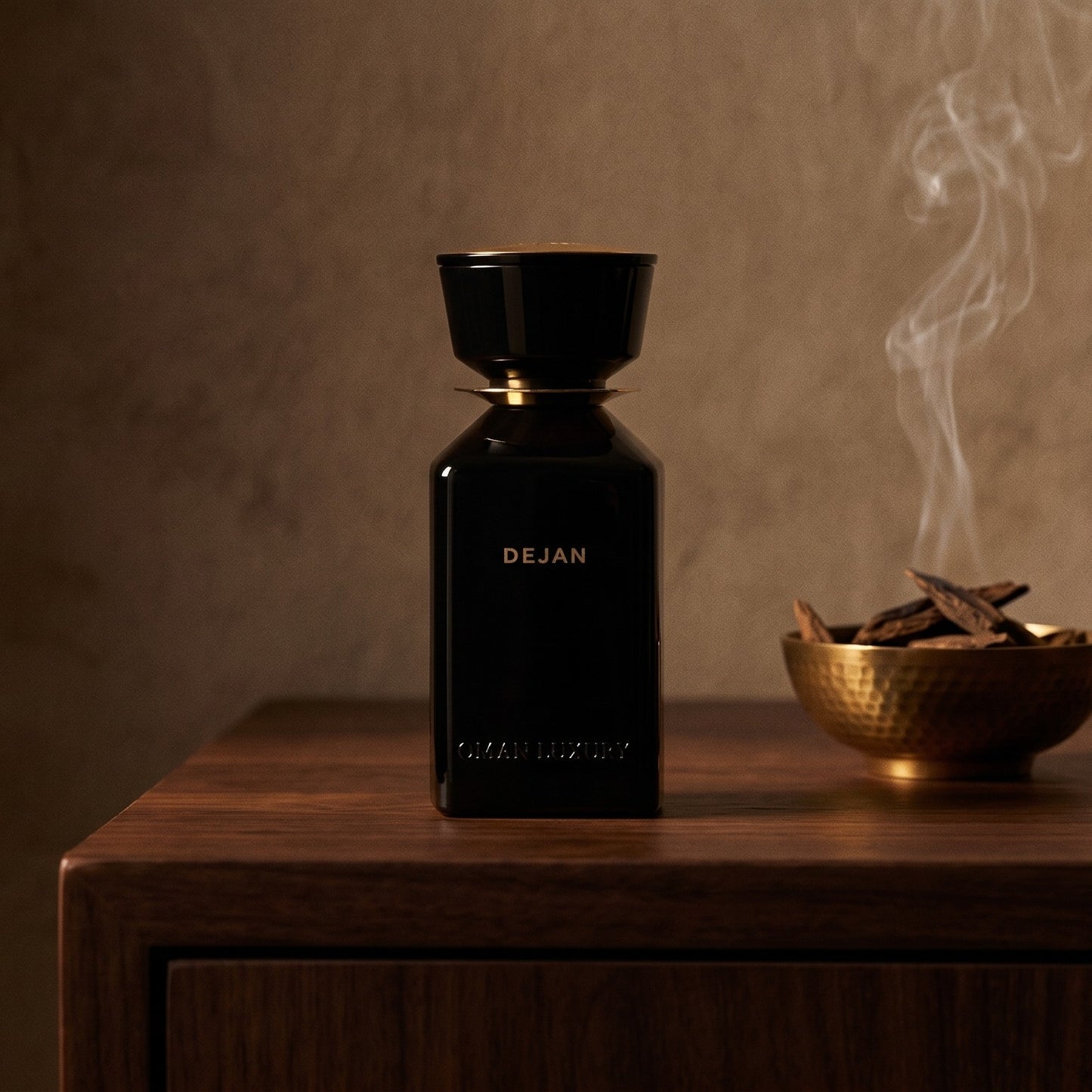 Oman Luxury Dejan EDP on dark walnut console with a small brass incense bowl with smoke curling upward