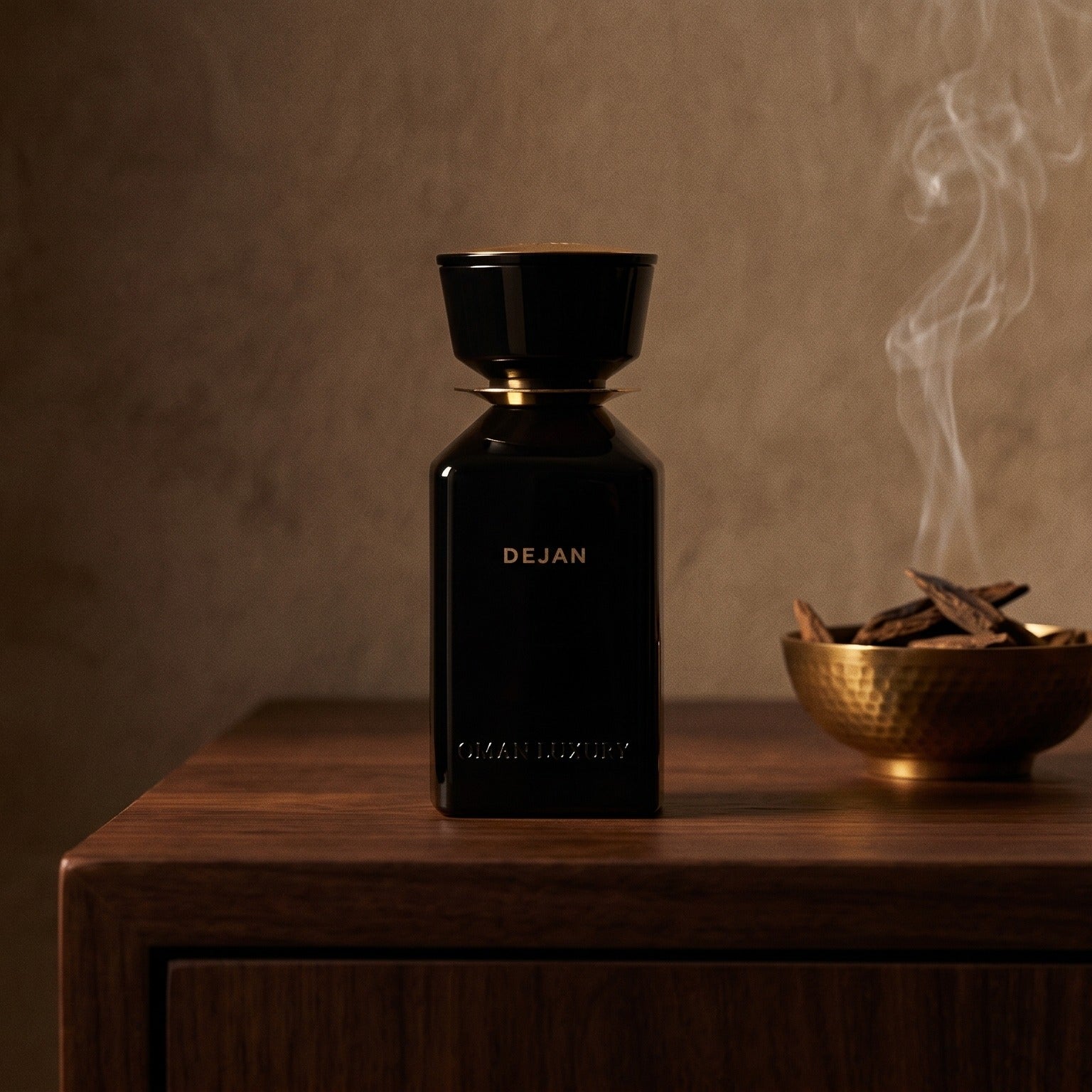 Oman Luxury Dejan EDP on dark walnut console with a small brass incense bowl with smoke curling upward