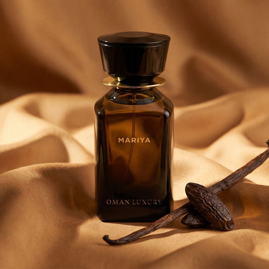 Oman Luxury Mariya EDP on warm caramel silk with a vanilla pod and tonka bean beside the bottle
