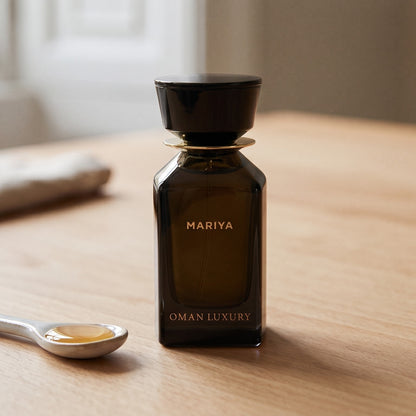 Oman Luxury Mariya EDP on pale beech wood with a small porcelain spoon with honey