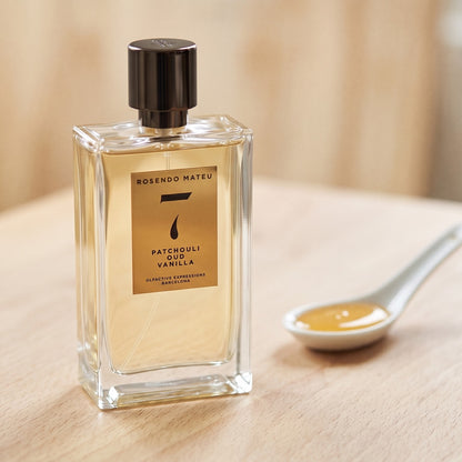 Rosendo Mateu No 7 EDP on pale beech wood with a small porcelain spoon with honey
