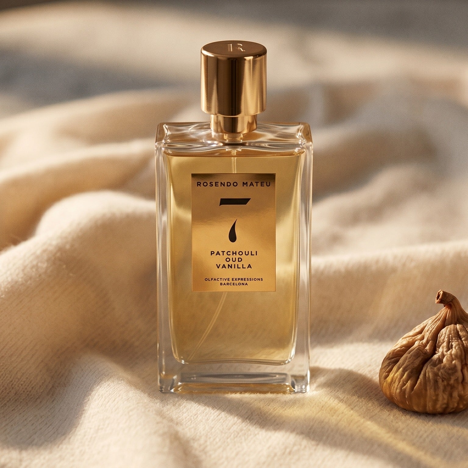 Rosendo Mateu No 7 EDP on cream cashmere with a single dried fig beside the bottle