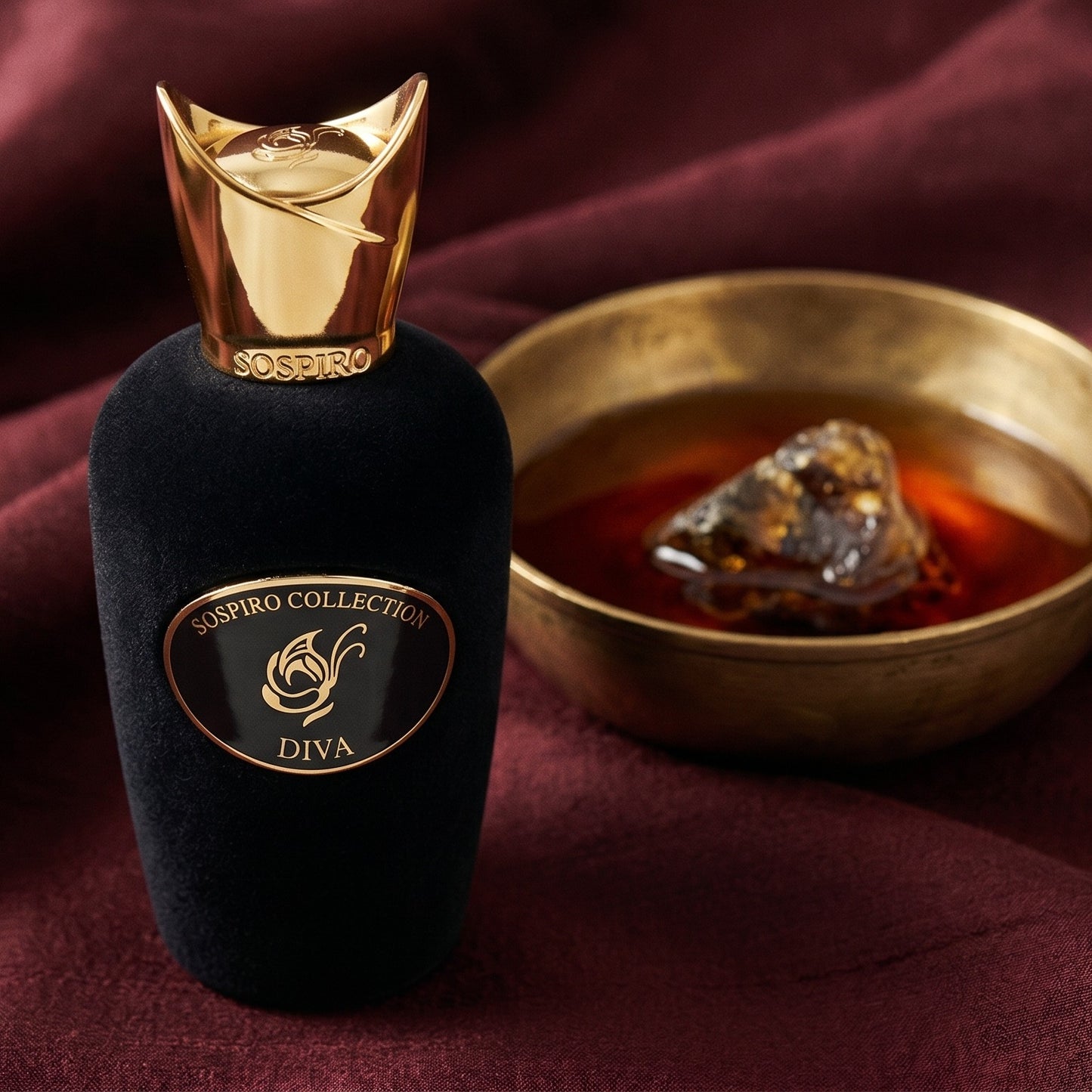 Sospiro Diva EDP on raw silk of oxblood color with a brass bowl with ambergris tincture