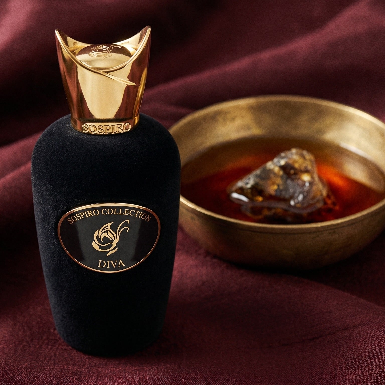 Sospiro Diva EDP on raw silk of oxblood color with a brass bowl with ambergris tincture