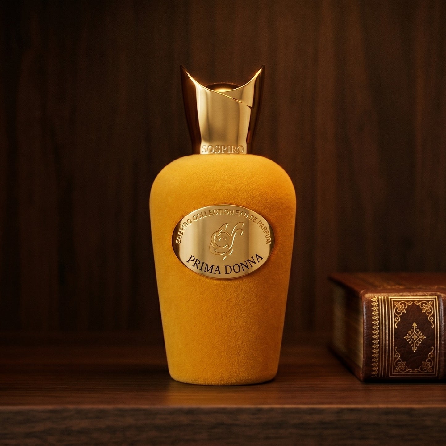 Sospiro Prima Donna EDP on dark walnut library shelf with a leather-bound book with gold foil