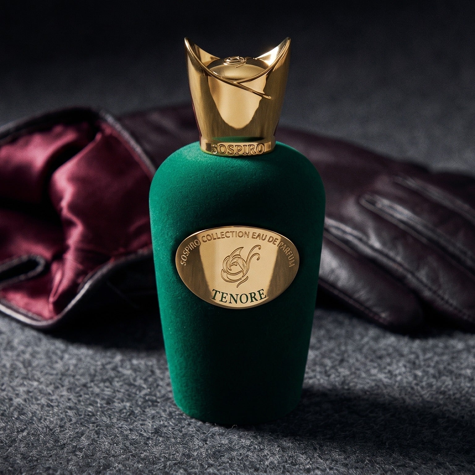 Sospiro Tenore EDP on charcoal felt with a silk-lined glove just behind the bottle