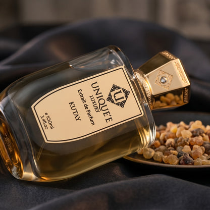 Unique Luxury Kutay Extrait on charcoal silk with frankincense resin granules in a small saucer
