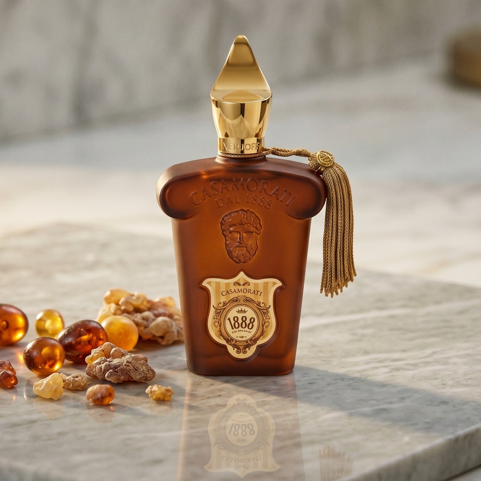 Xerjoff Casamorati 1888 EDP on pale grey marble with amber resin beads scattered to one side