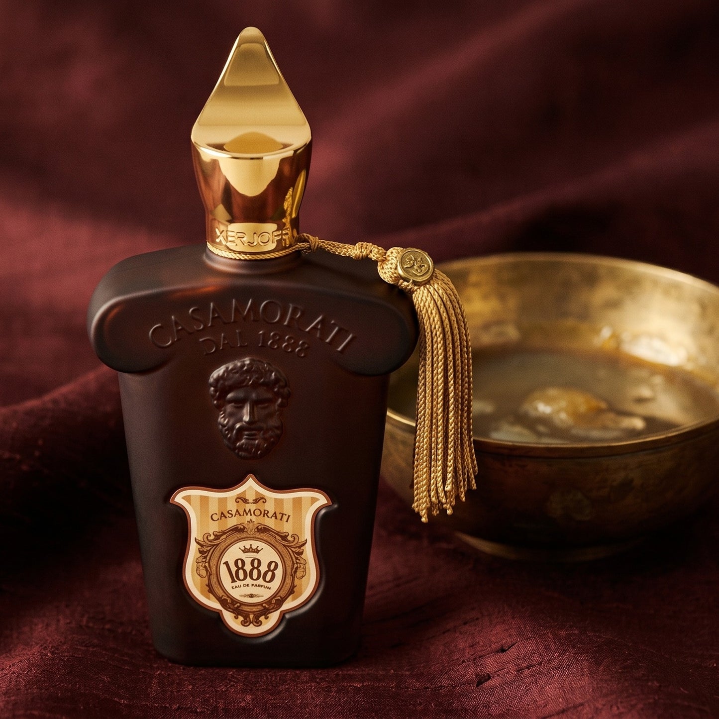 Xerjoff Casamorati 1888 EDP on raw silk of oxblood color with a brass bowl with ambergris tincture
