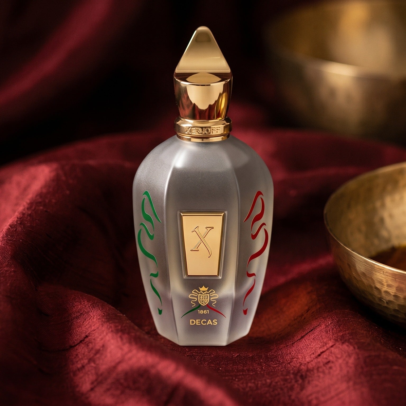 Xerjoff Decas EDP on raw silk of oxblood color with a brass bowl with ambergris tincture