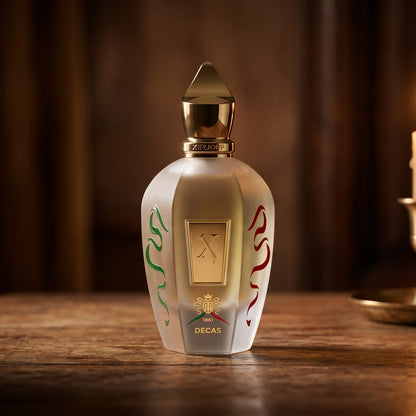 Xerjoff Decas EDP on aged teak with a candle burning gently to frame-right