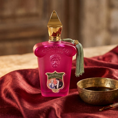 Xerjoff Gran Ballo EDP on raw silk of oxblood color with a brass bowl with ambergris tincture