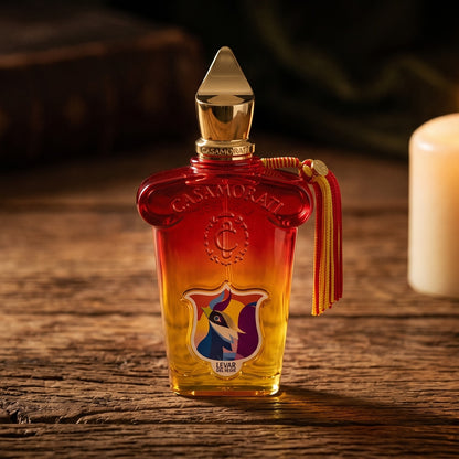Xerjoff Levar Del Sole EDP on aged teak with a candle burning gently to frame-right