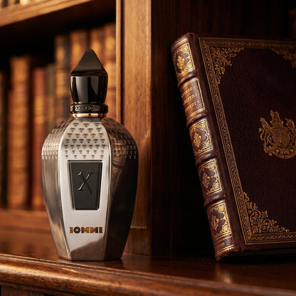 Xerjoff Monkey Special Tony Iommi EDP on dark walnut library shelf with a leather-bound book with gold foil