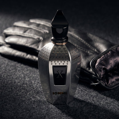 Xerjoff Monkey Special Tony Iommi EDP on charcoal felt with a silk-lined glove just behind the bottle