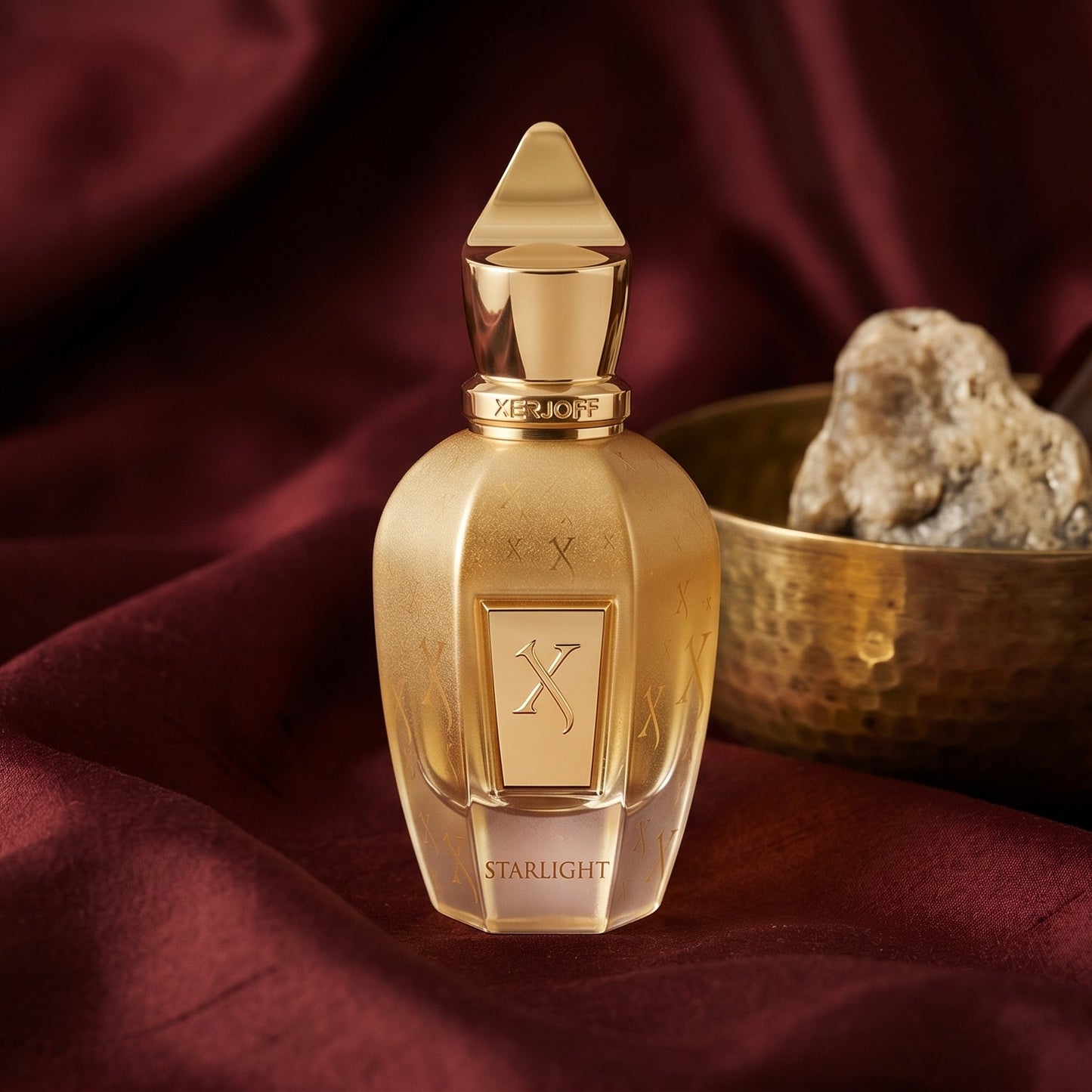 Xerjoff Starlight Parfum on raw silk of oxblood color with a brass bowl with ambergris tincture