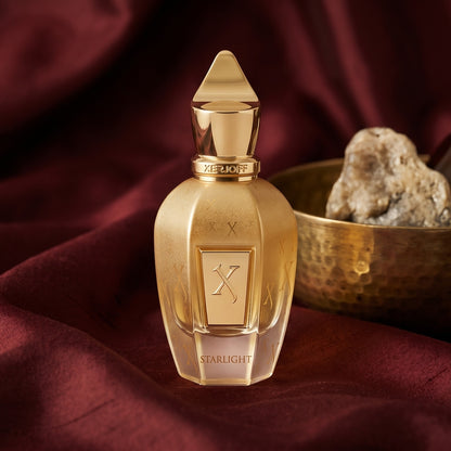 Xerjoff Starlight Parfum on raw silk of oxblood color with a brass bowl with ambergris tincture
