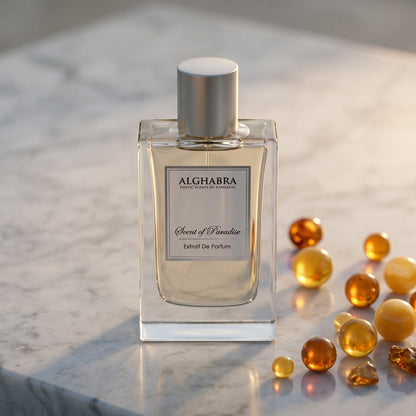 Alghabra Scent of Paradise EDP on pale sandstone with golden amber shards catching the light