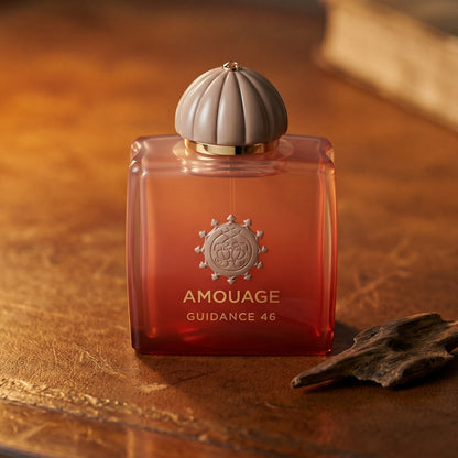 Amouage Guidance 46 EDP on worn saddle-leather surface with oud resin chunks in a small dish