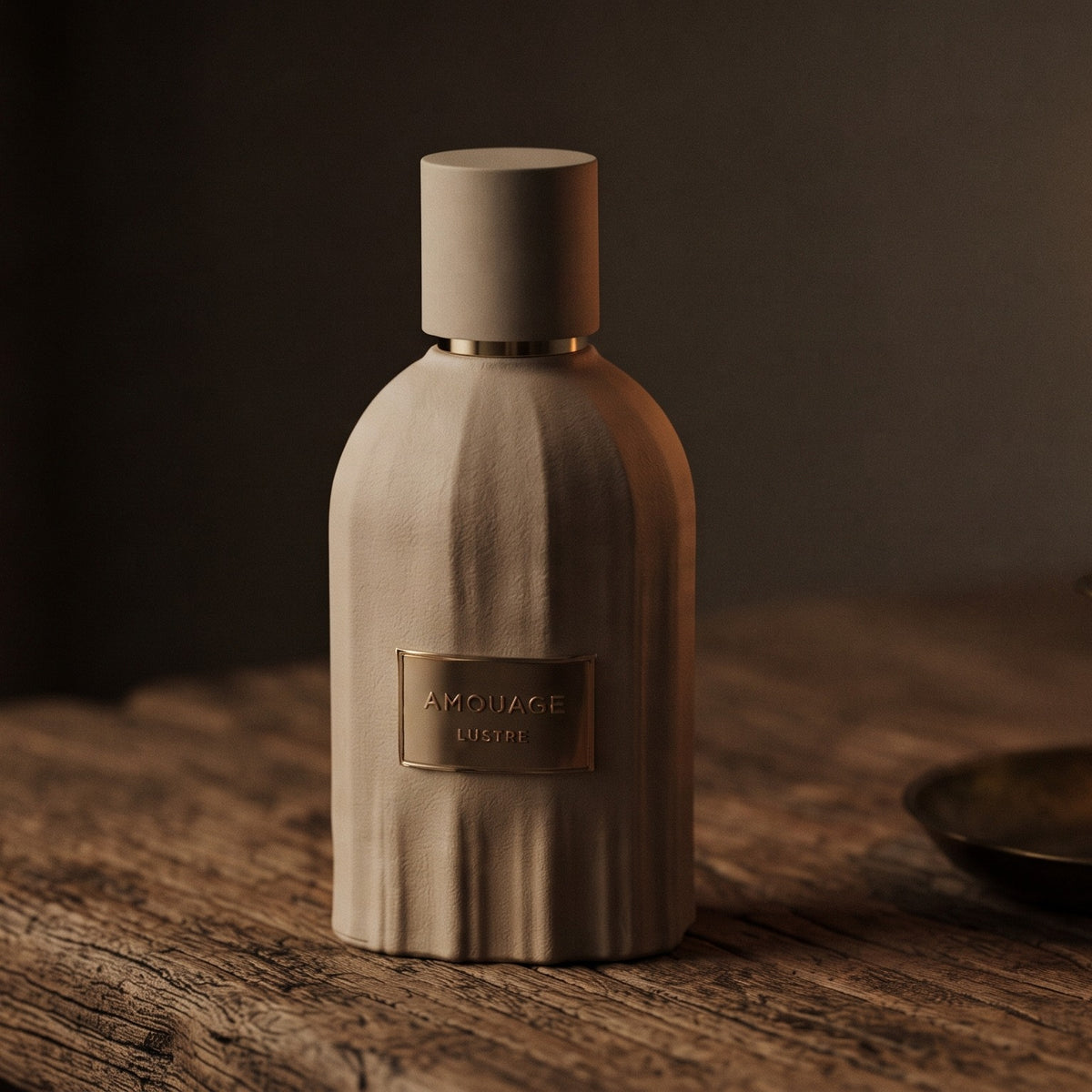 Amouage Lustre Essence de Parfum on aged teak with a candle burning gently to frame-right