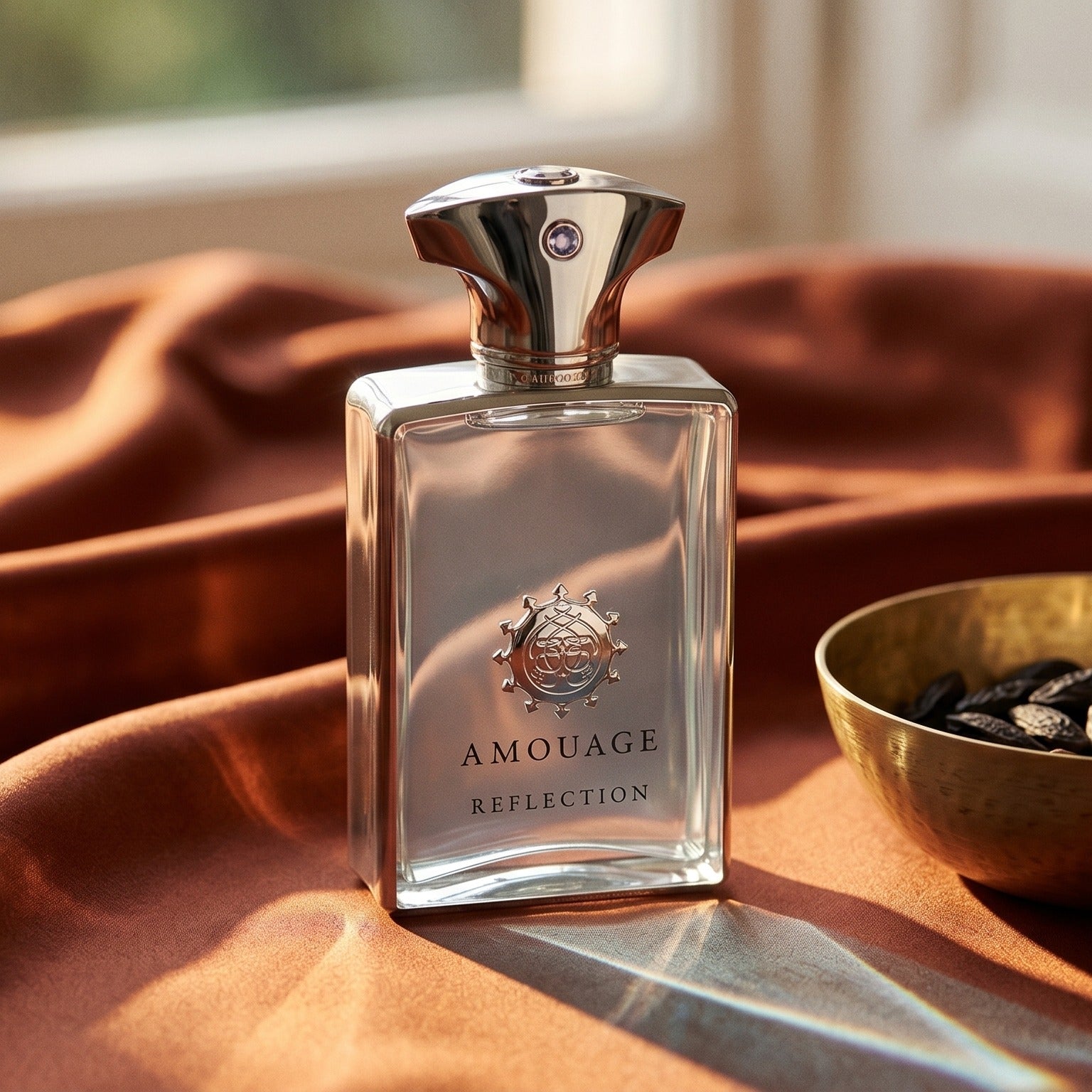 Amouage Reflection EDP on russet silk with a matte brass bowl holding tonka and incense