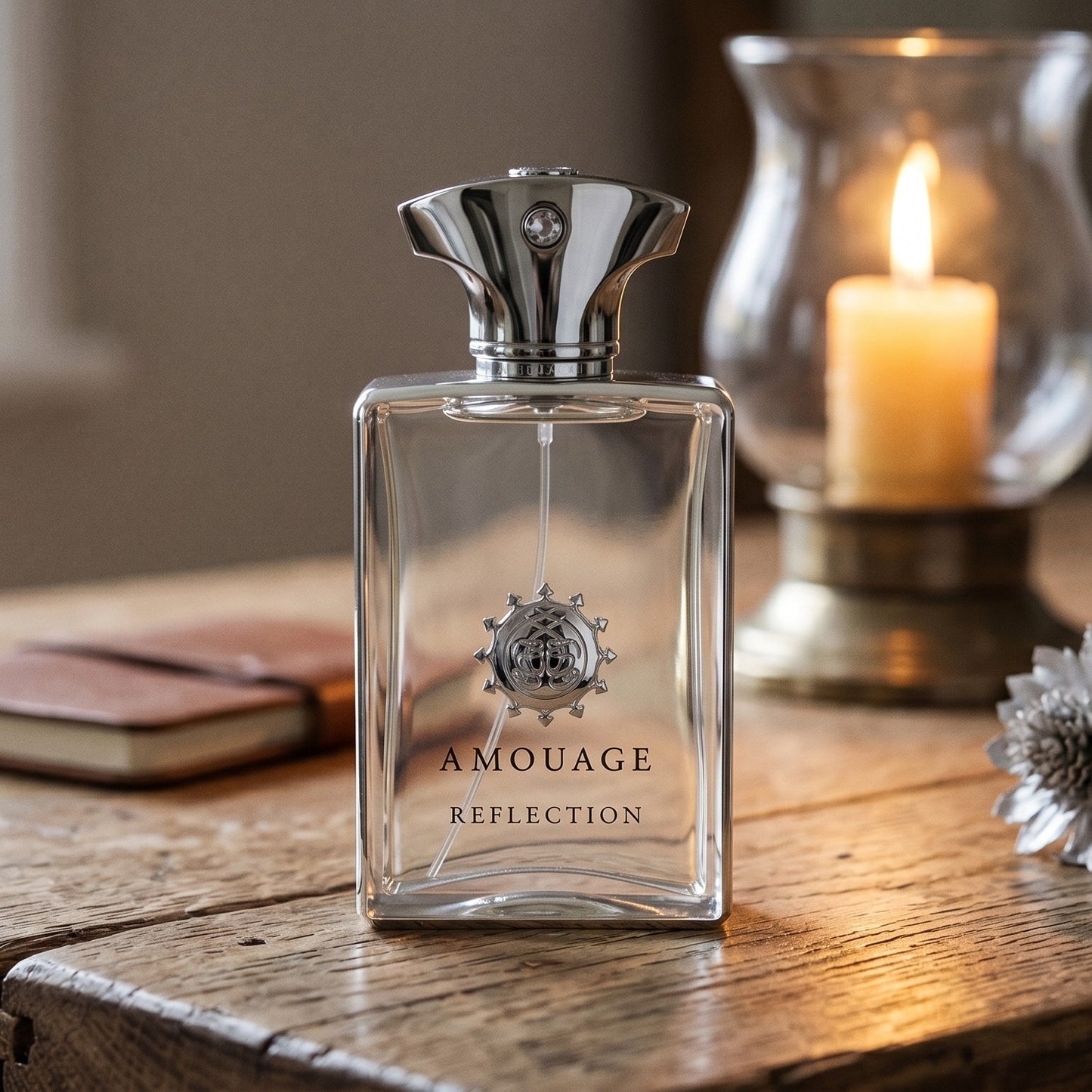 Amouage Reflection EDP on reclaimed oak surface with a glass hurricane lamp softly lit