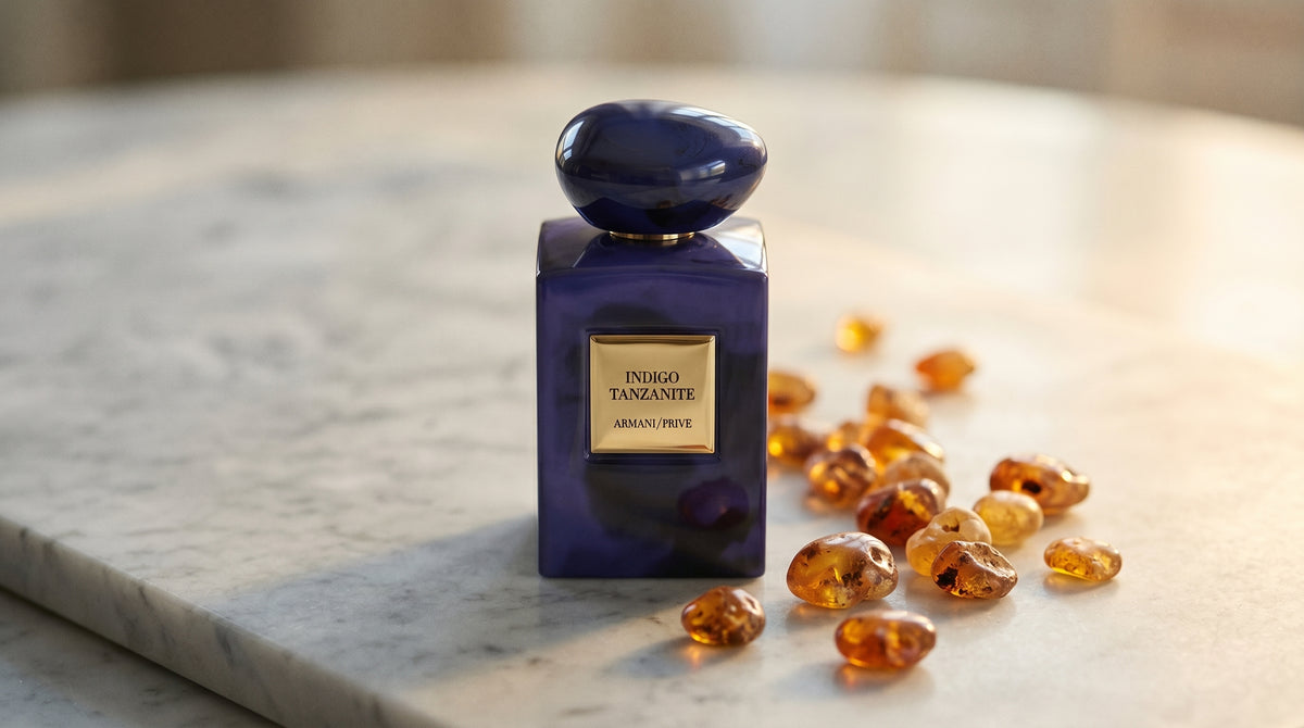 Armani/Prive Indigo Tanzanite on pale grey marble with amber resin beads scattered to one side