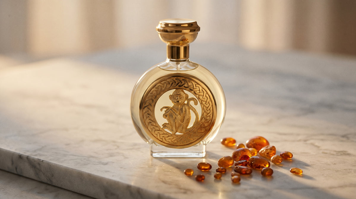 Boadicea Hanuman EDP on pale grey marble with amber resin beads scattered to one side